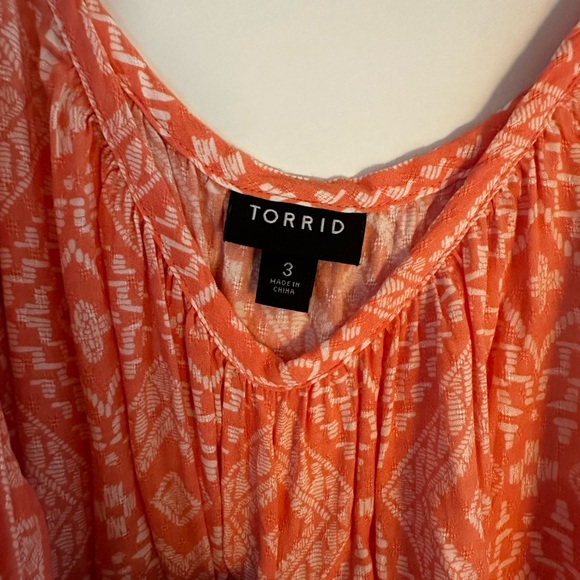 Orange and white patterned Torrid cold shoulder top with sleeves. - Picture 3 of 5